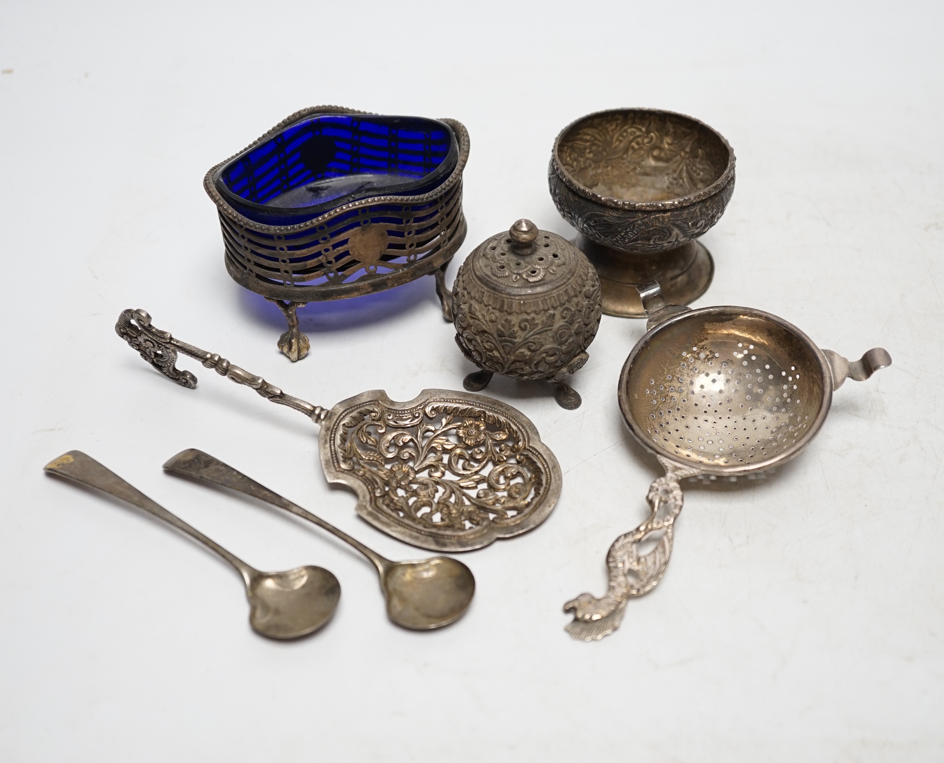 A group of small silver and white metal items including a George III oval salt, two Georgian condiment spoons, Indian condiment, etc. Condition- Fair.